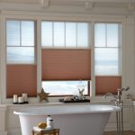 Custom colored celluar shades in a bathroom
