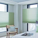 Green motorized cellular shades in bedroom of beautiful home