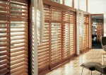 Beautiful office that has plantation shutters over windows