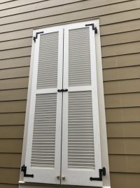 White exterior shutter with black hardware