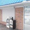 Metal hurricane shutters covering convenience store windows
